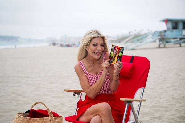 Tori Spelling enjoys a family beach day with her beach essentials.