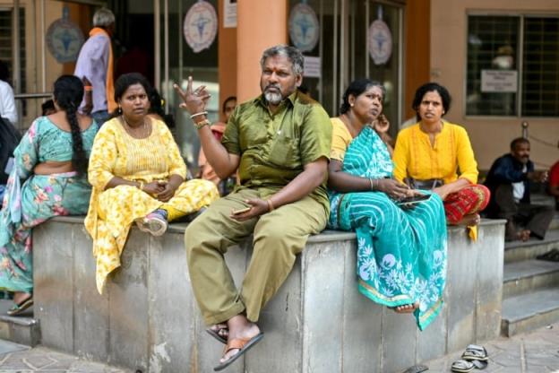 People wait outside a closed outpatient department in Bengaluru, India.